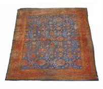 An Ushak carpet, blue field with all-over paterae and palmette motifs within a red border,