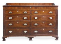 A George III mahogany ‘mule’ chest, circa 1800, with a rear gallery and a hinged lid opening to a