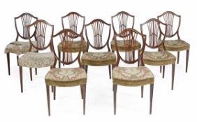 A set of nine mahogany shield back dining chairs in George III style by Howard & Son, 20th