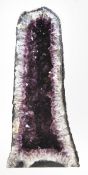 An amethyst ‘cathedral’ geode, probably Brazilian, of slender arching form, 78cm high