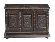 A Charles I panelled oak chest, circa 1660, the chest with a hinged lid above a triple panelled