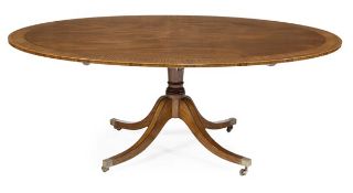 A mahogany and crossbanded oval topped centre table in Regency style, of recent manufacture, on a
