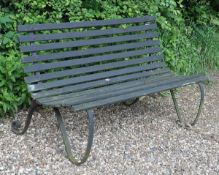 A painted wrought iron and wood slatted garden bench, second quarter 20th century, with scrolled