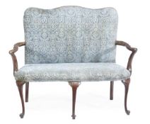 A George II walnut settee, circa 1750, with a rectangular padded back, above open arms and a