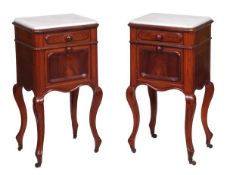 A pair of Victorian mahogany bedside cupboards, circa 1870, each white marble inset top above a