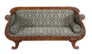 A mahogany and upholstered sofa, in Empire style, 20th century, with an overstuffed back,