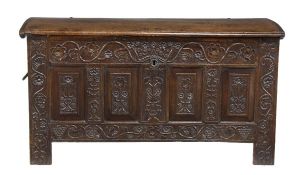 A Continental carved oak coffer, 17th century, the domed top opening to two candle boxes, the