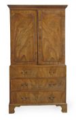 A George III mahogany clothes press, circa 1780, the dentil moulded cornice above a pair of panelled