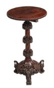 An Anglo-Indian hardwood occasional table, 20th century, the circular top above an elaborate