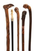 An Italian carved and stained wood walking stick, late 19th century, the integral root grip