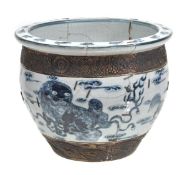 A Chinese blue and white jardinniere decorated with mythical beasts amid scrolling clouds and