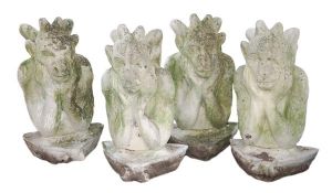 A set of four reconstituted stone garden models of winged gargoyles, late 20th century, cast to the