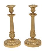 A pair of French gilt bronze candlesticks in 18th century style, late 19th century, the urn sockets