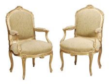 A pair of giltwood framed and upholstered armchairs in Louis XV style, late 19th/early 20th