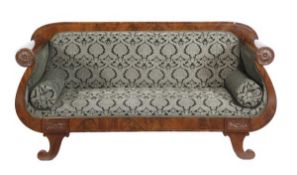 A mahogany and upholstered sofa, in Empire style, 20th century, with an overstuffed back, scrolling