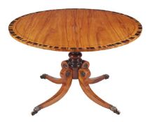 A Regency mahogany and coromandel crossbanded circular centre table, circa 1815, the top with