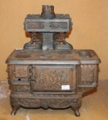 A vintage childs cast iron stove; 37cm high Best Bid