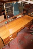 A 1960`s Newbury & Spinder of Bristol teak dressing table.152cm wide