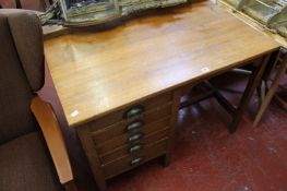 A 1930s oak clerks desk, a cane seat chair, wall shelf and bookcase.