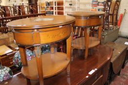 A pair of cherry and marble inset oval two tier tables each 63cm wide