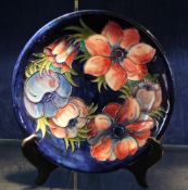 A Moorcroft anemone plate; initialled, stamped and label verso; 26cm diameter