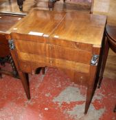 An Empire mahogany night stand with hinged lid, revealing an adjustable mirror, with three drawers