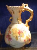 A Royal Worcester blush ground, coral handled jug, shape number 1507 decorated with flowers in the