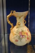 A Royal Worcester blush ground, coral handled jug, shape number 1507 decorated with flowers in the