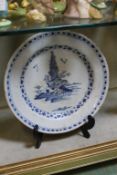 An English Delft blue and white plate with chinoiserie decoration, circa 1760; 23cm diameter