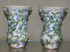 A pair of Meissen floral encrusted vases (lacking covers); 16.5cm high each (2)