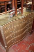 A modern silver/ gold decorated serpentine chest with three short and three long drawers 121cm wide