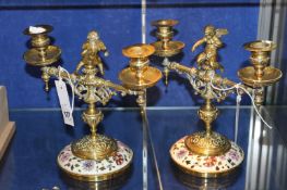 A pair of Victorian brass and polychrome ceramic mounted turned light candelabra, each