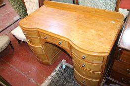 A pine desk with nine short drawers 123cm wide