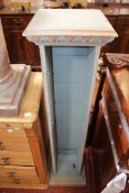 A terracotta plinth 56cm high, a pine five drawer chest  and a painted pine rack