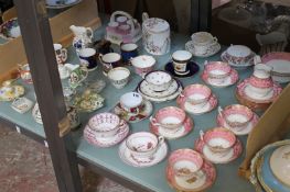 A Mintons pink and gilt part tea service, two pink lustre cups and saucers, together with further