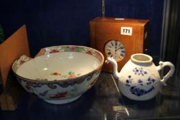 A Chinese famille rose bowl (a/f), 22.5cm diameter, a small blue and white Chinese teapot (a/f) and