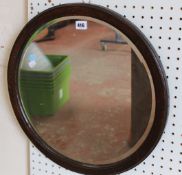 An Edwardian mahogany and satinwood banded oval wall mirror, and further wall mirror (2)