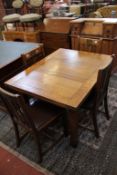 An oak drawleaf table and four chairs.160cm extended