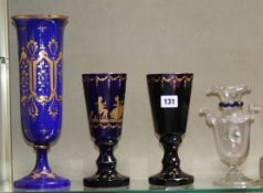 A Facon de Venise style glass vase, a blue and gilt glass vase, a similar goblet, an amber glass