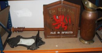 A dart board held in wooden case painted with `The Red Lion` pub advertising sign, a large copper