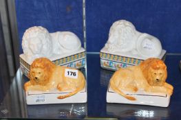 A pair of `Palais De Versailles` porcelain trinket boxes and covers modelled as recumbent lions