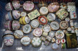 An assortment of enamel trinket boxes including a Halcyon Days Glyndebourne example with exclusive