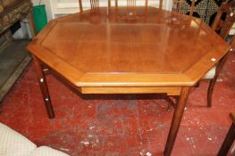 A modern octagonal stained carved wood dining table, probably Chinese 152cm diameter