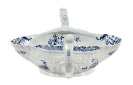 A Worcester blue and white two-handled sauceboat, circa 1758, painted with the  A Worcester blue