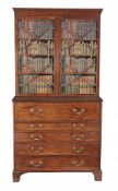 A George III mahogany secretaire bookcase circa 1770 the moulded cornice...  A George III mahogany