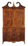 A George III mahogany and inlaid linen press circa 1790 with a broken swan...  A George III