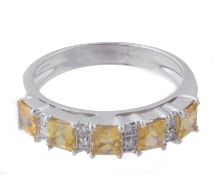 A yellow sapphire and diamond ring, set with five square shaped yellow...  A yellow sapphire and
