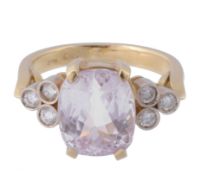 A kunzite and diamond ring, the central oval shaped kunzite in a four claw...  A kunzite and diamond