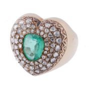 An emerald and diamond heart ring, the central oval shaped emerald within a...  An emerald and