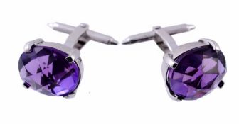 A pair of amethyst cufflinks, the oval faceted amethyst in a four claw setting  A pair of amethyst